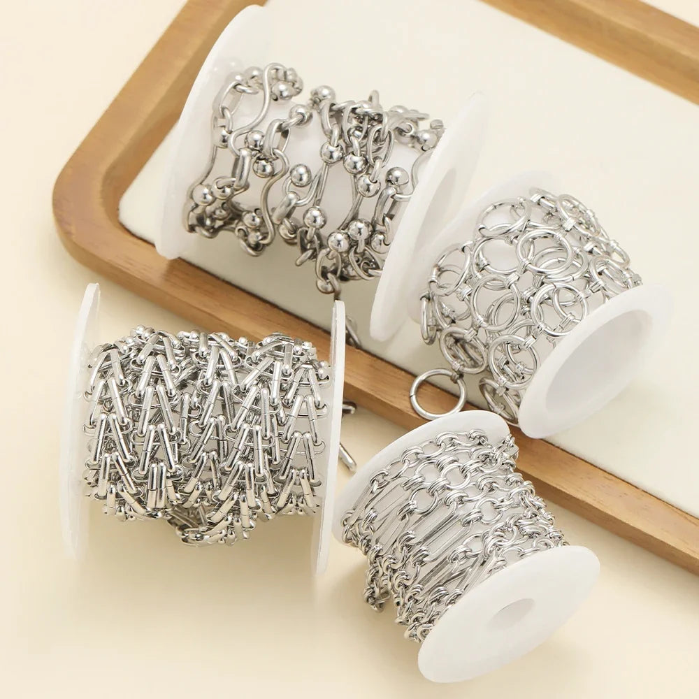 Stainless steel chain necklace set on white display, mixed link bracelet chains