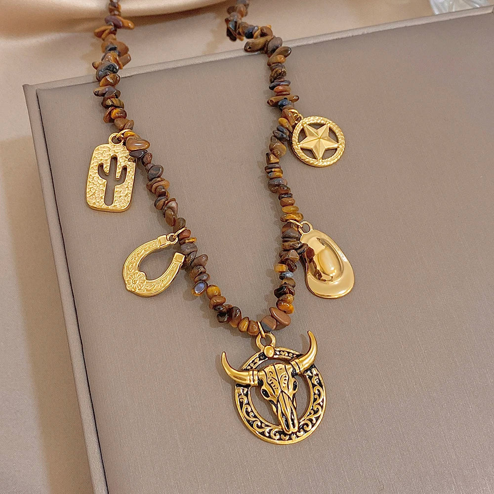 Gold-tone beaded necklace with cactus, crescent charms, star disc and bull head pendant