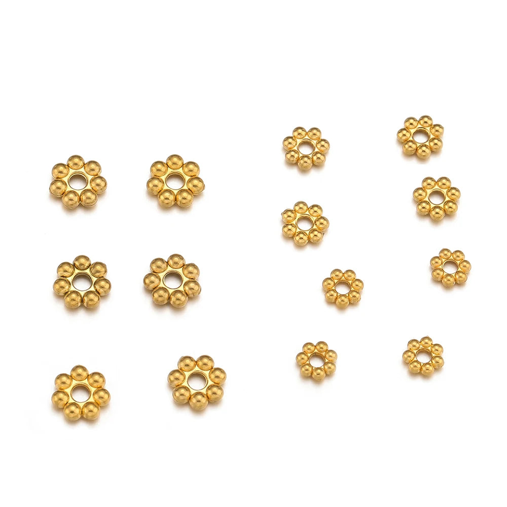 Gold flower-shaped spacer beads, round ball cluster with center hole detail.