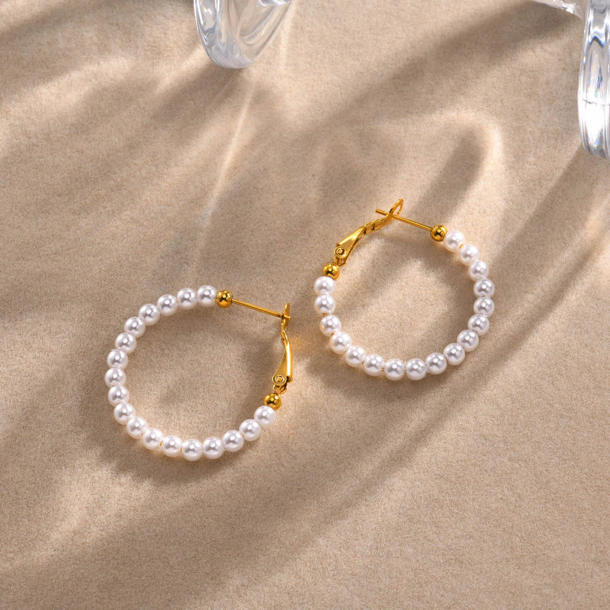 Pair of simulated pearl hoop earrings with gold-tone clasps