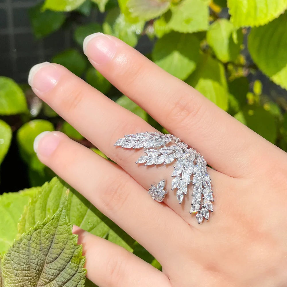 Silver-tone adjustable ring with a sweeping leaf design set with clear stones