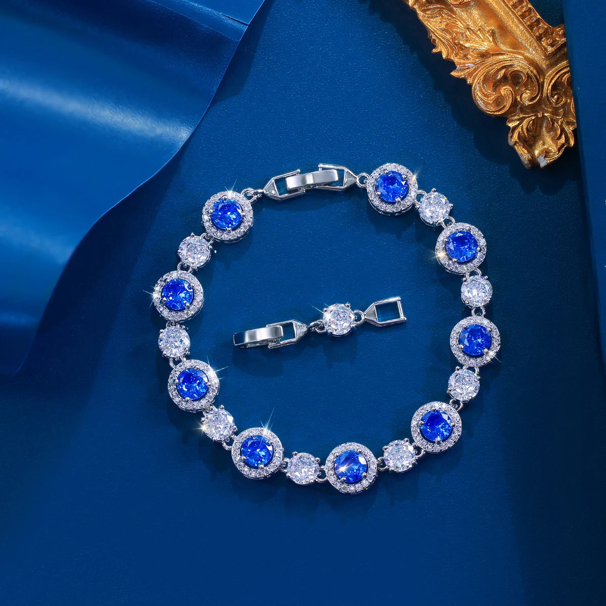 Silver-tone tennis bracelet with round blue stones alternating with clear stones