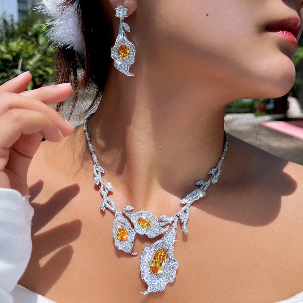 Calla lily necklace and earring set worn, showing the yellow stones and floral design