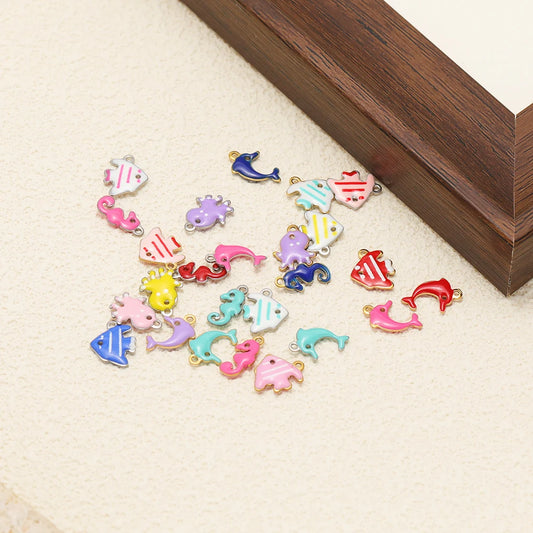 Enamel marine animal charms set with dolphins, seahorses, octopus, and fish designs