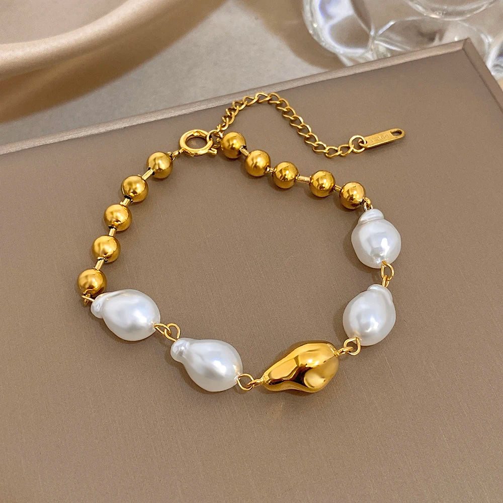 Gold-tone slim chain bracelet with pearl beads and gold leaf heart charm