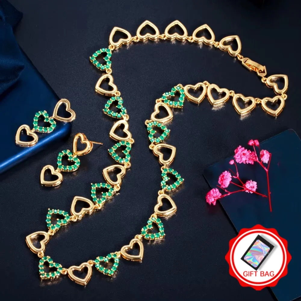 Gold-tone heart necklace and earrings with green stones