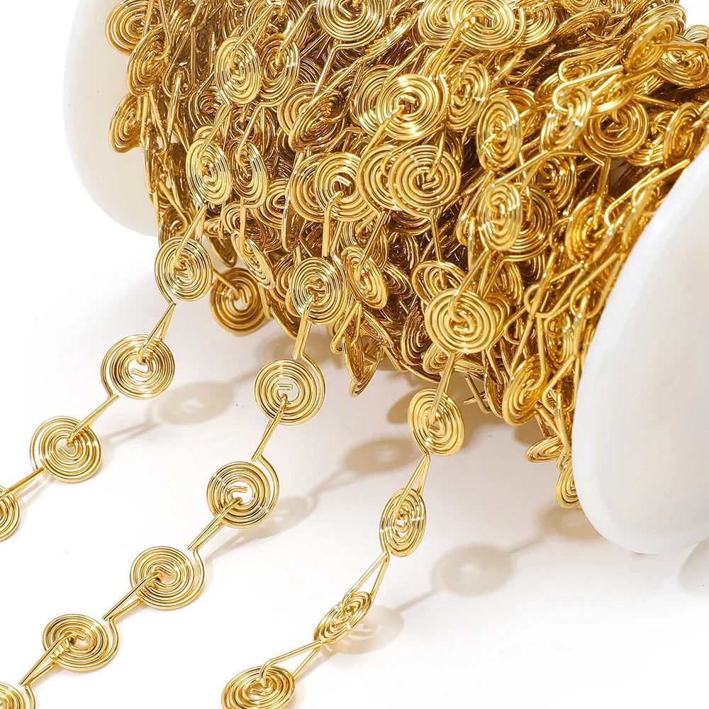 Close-up of gold spiral chain with round swirl flower links