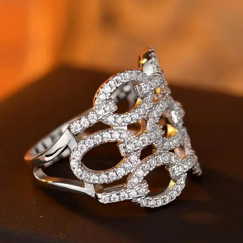 Silver-tone openwork crystal ring with prong-set sparkle and curved band