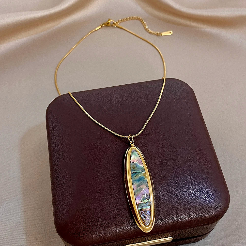 Gold-tone oval abalone pendant on thin snake chain necklace