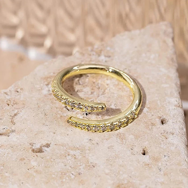 Gold open zirconia band ring with textured edges and round clear stones