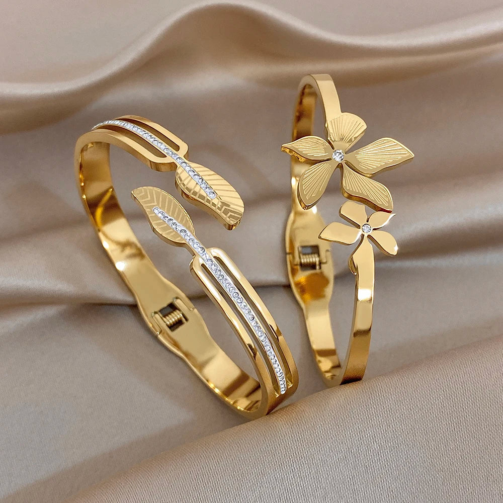 Gold plated stainless steel cuff bracelets with leaf and flower zircon accents