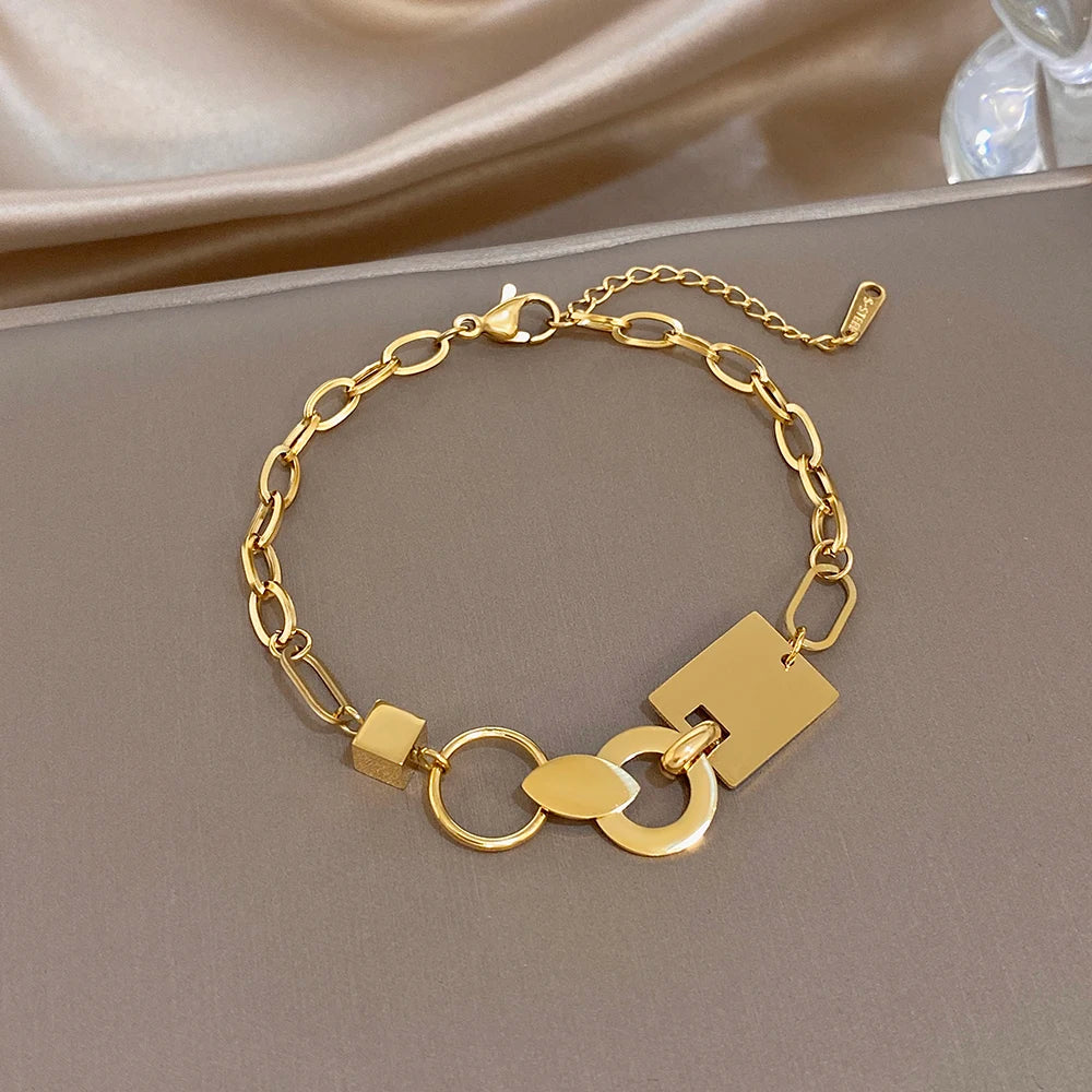 Gold-tone slim chain bracelet with ring and large rectangular charm