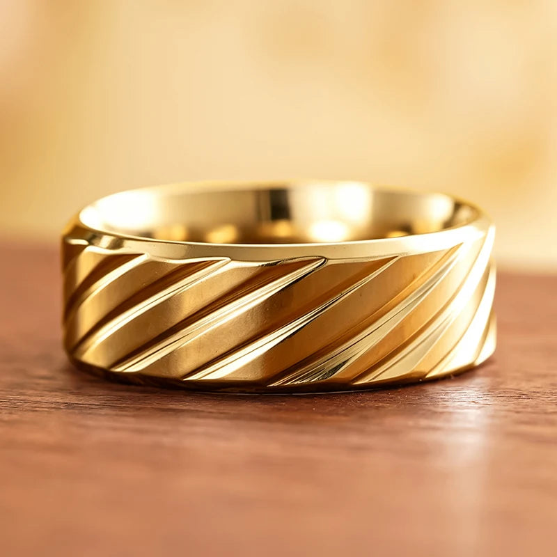 Gold-tone diagonal groove band ring with diagonal stripe grooves and glossy finish