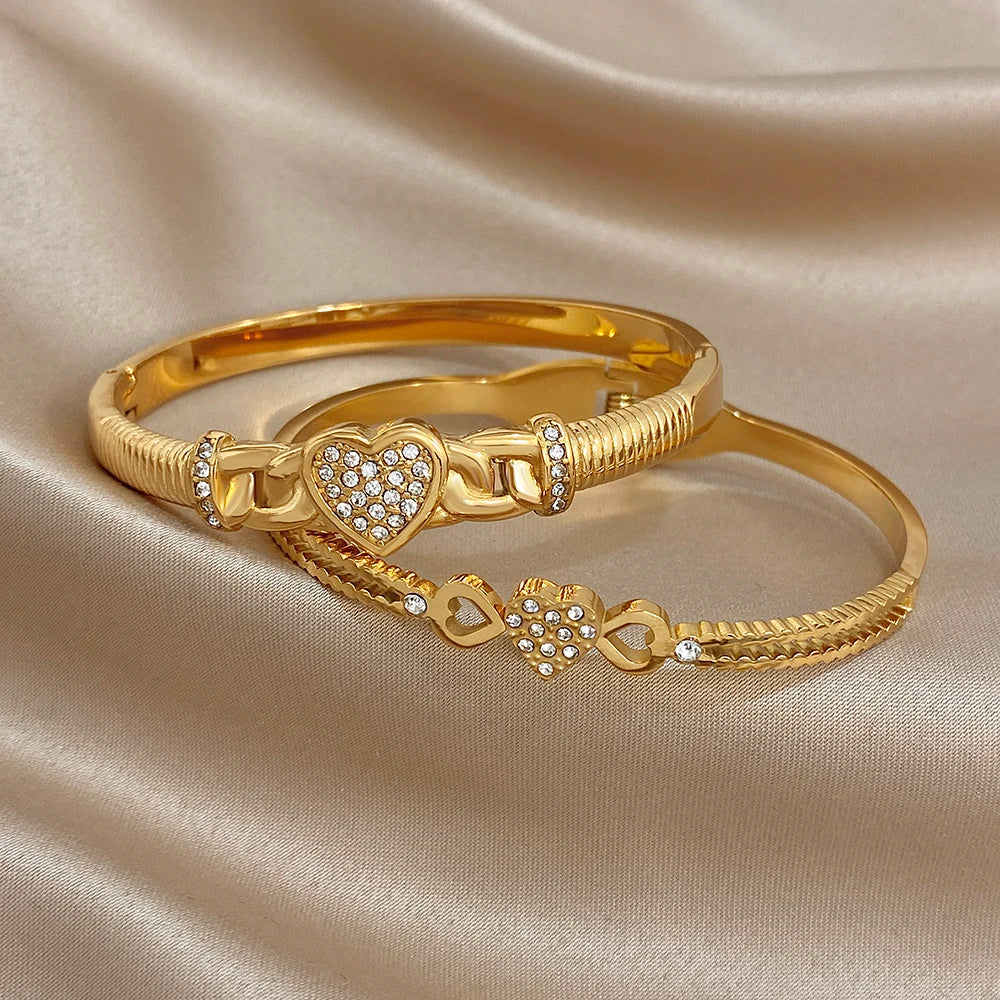 Gold-tone heart charm cuff bangle set with braided texture and clear rhinestones