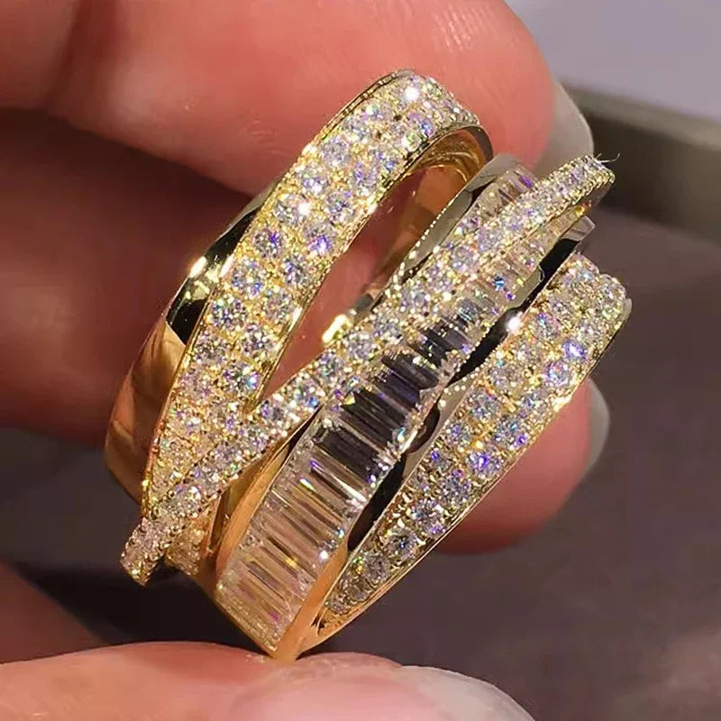 Gold-tone CZ cross-over open band ring with wide glitter band and baguette center row