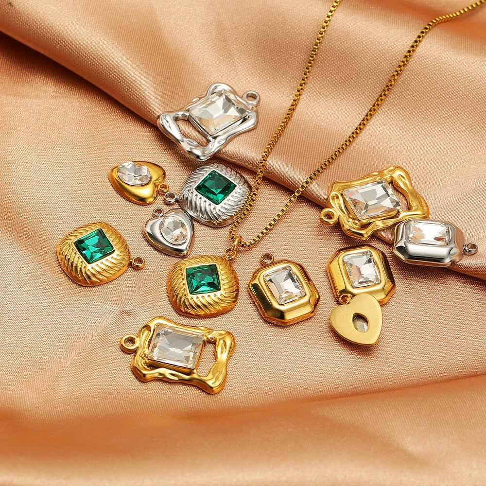 Gold and silver square charm pendants with clear rhinestones and green centers