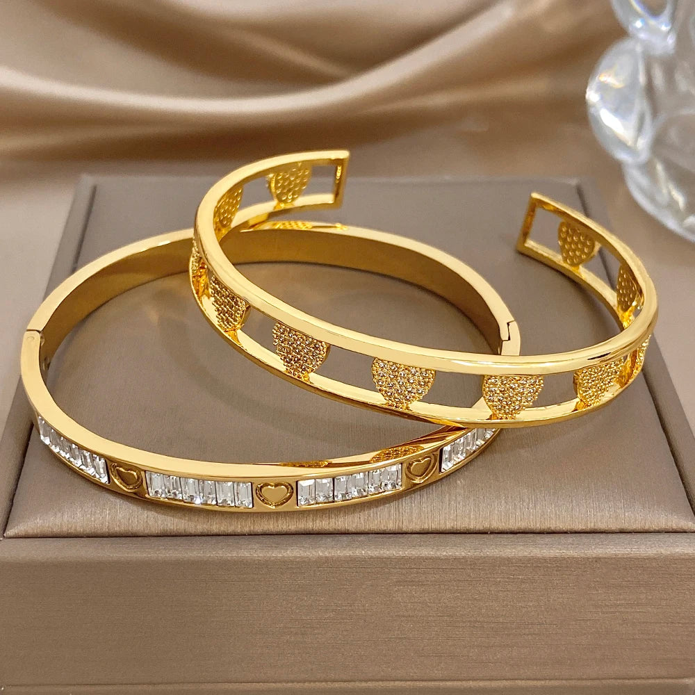 Shiny gold heart and rhinestone cuff bangle set, two stacked hinged bracelets
