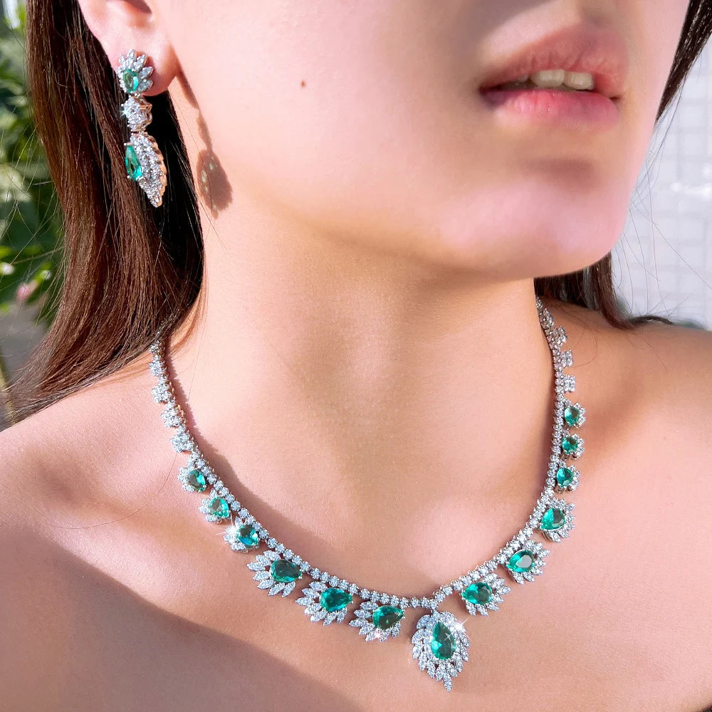 Teal and clear stone necklace with matching drop earrings, silver-tone setting
