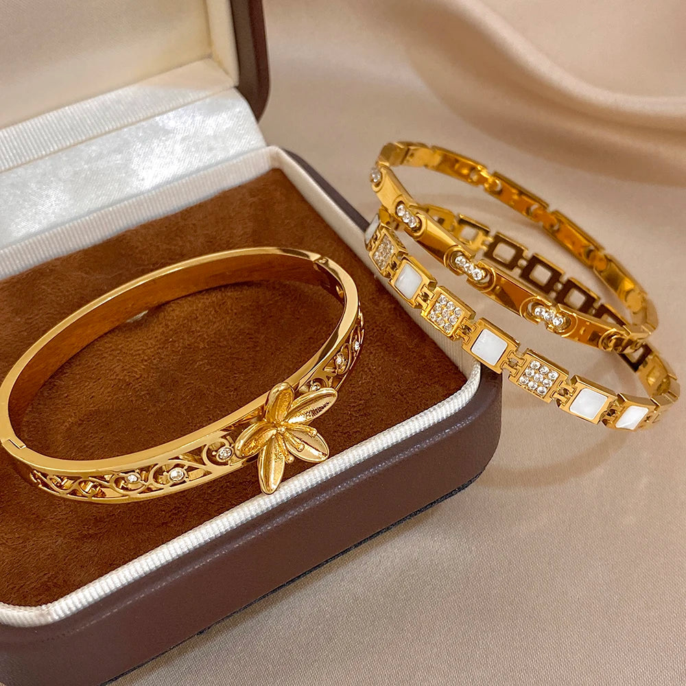 Gold-plated flower cuff bangles with square crystal and geometric link details, two-piece
