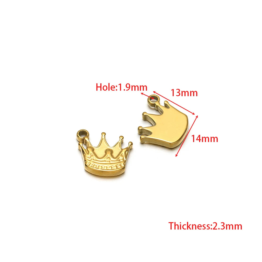 Gold crown charm and gold dolphin-shaped charm with loop bail