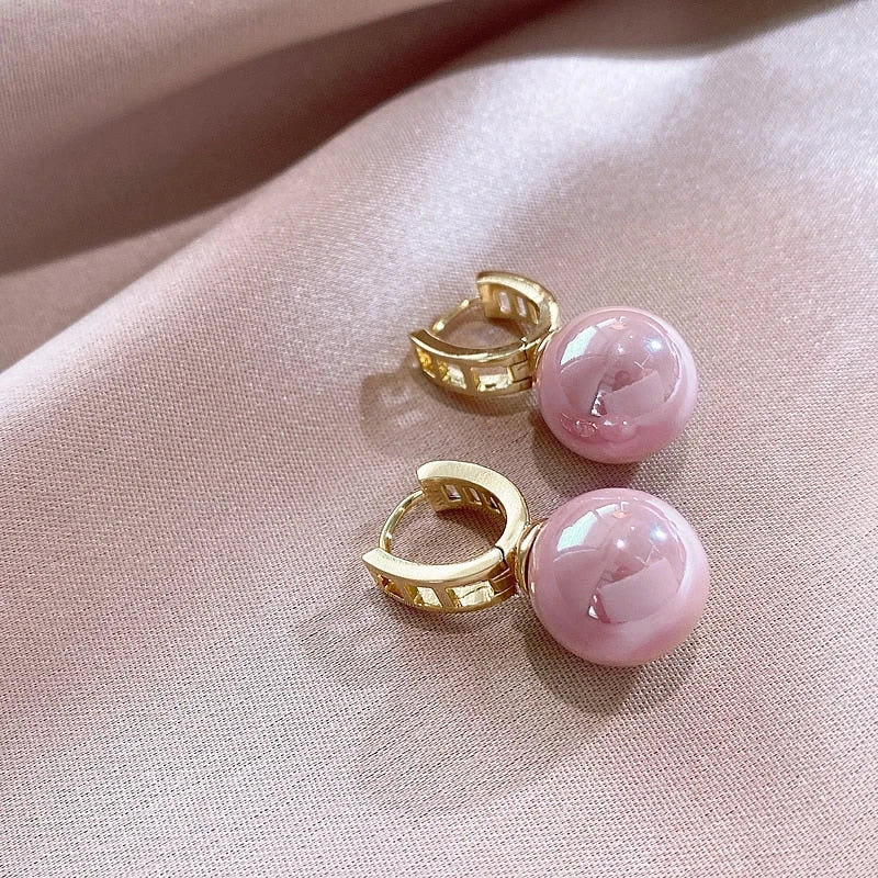 Gold-tone hoop earrings with round pink imitation pearl drops