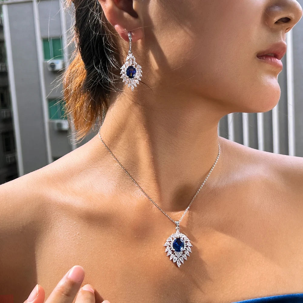 Blue CZ pendant necklace and matching drop earring shown worn