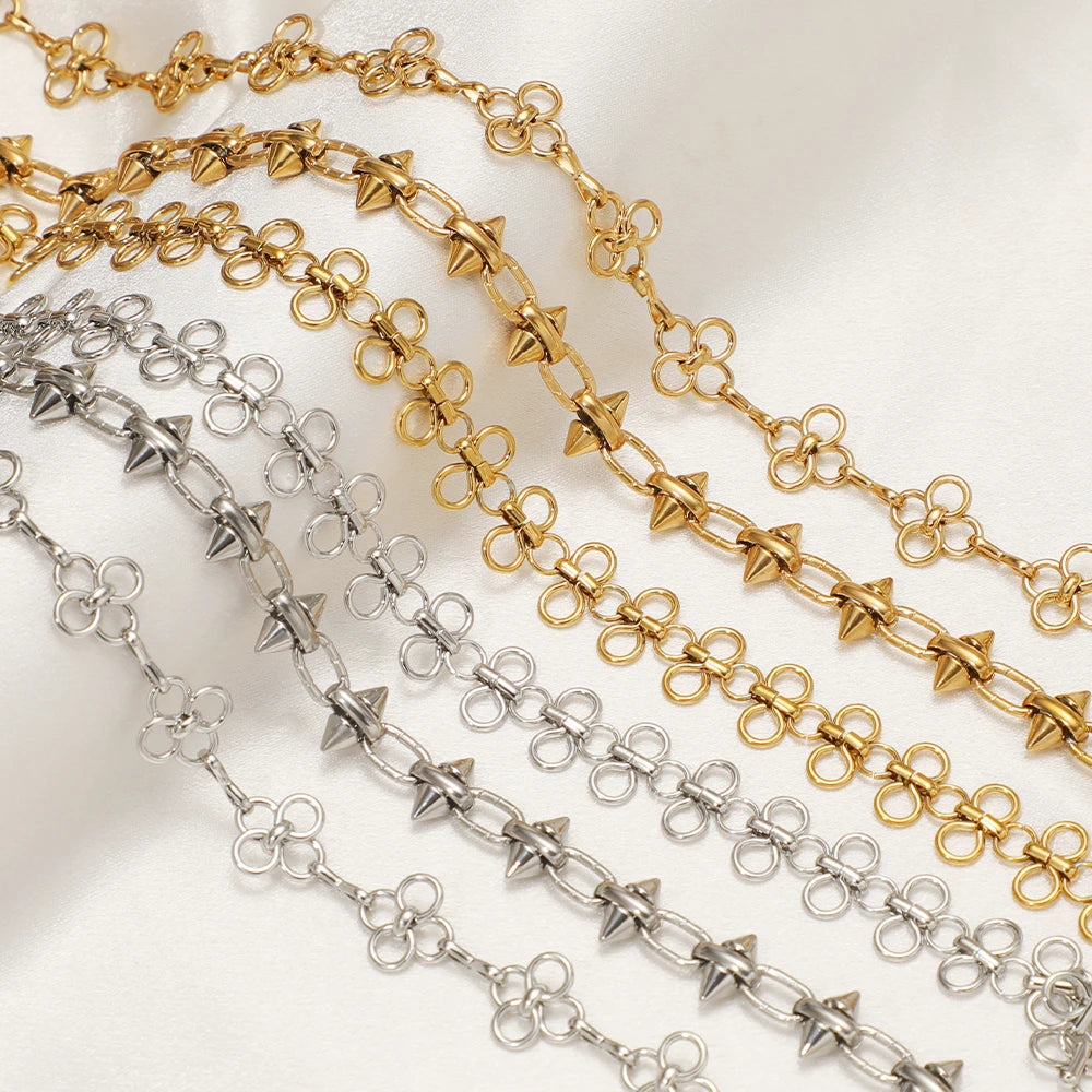 Gold and silver-toned bow knot chain strands laid flat with repeating links
