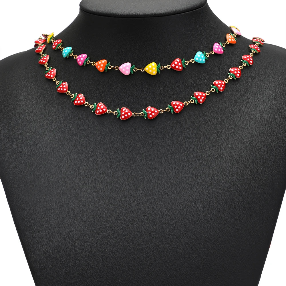 Enamel strawberry charm necklace with gold-tone links in red and turquoise colors