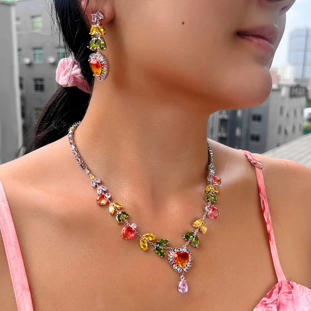 Close view of multicolor heart zircon necklace and drop earring worn