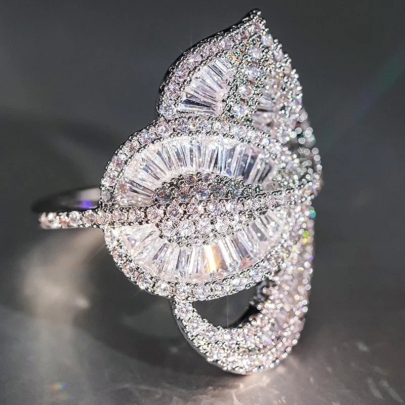 Sparkly crystal leaf-style finger ring with clear stones, silver tone, irregular band