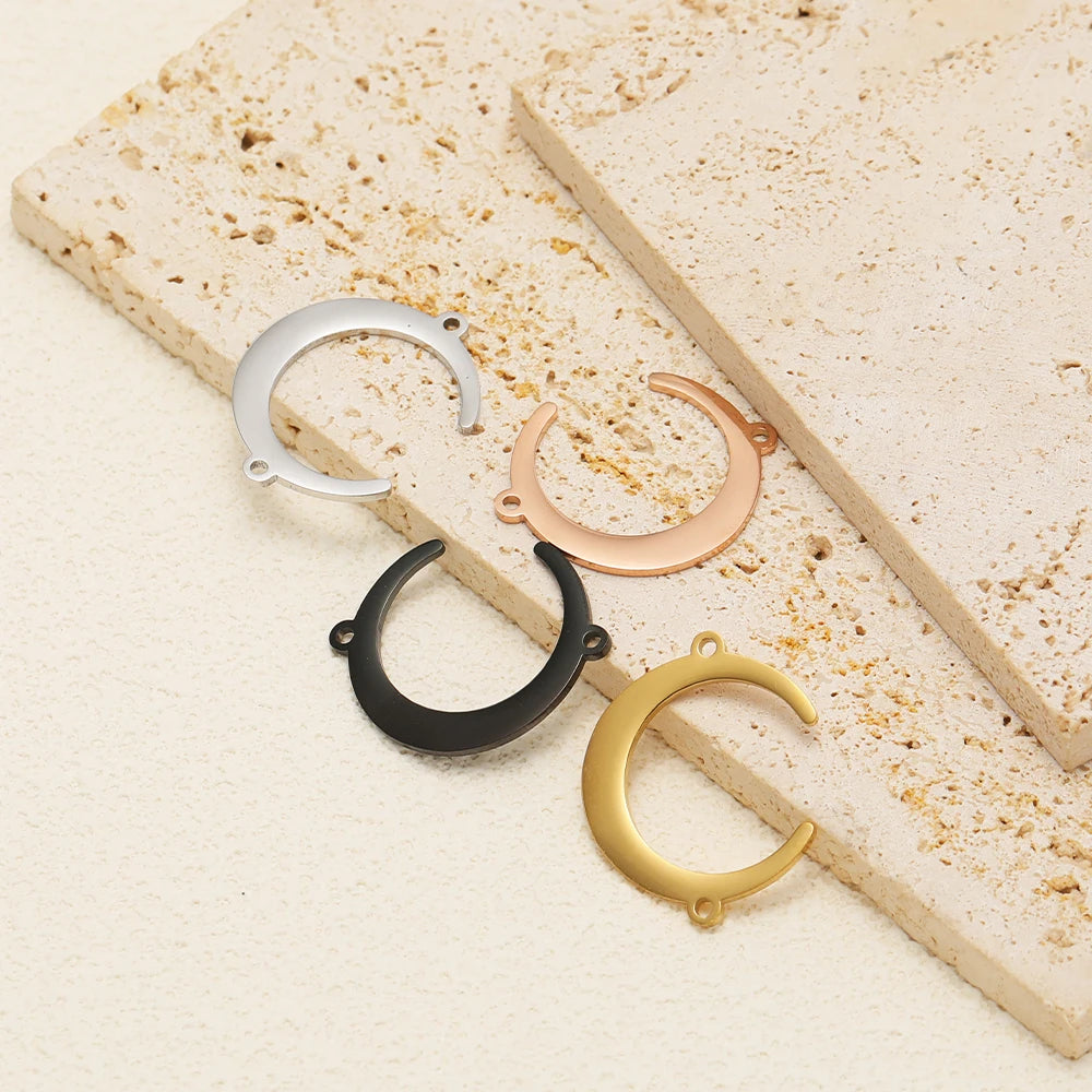 Moon-shaped pendant charms set with double-hole connectors in mixed stainless finishes