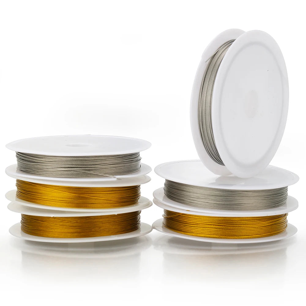 Stainless steel beading wire cord rolls, gold and steel on white spools