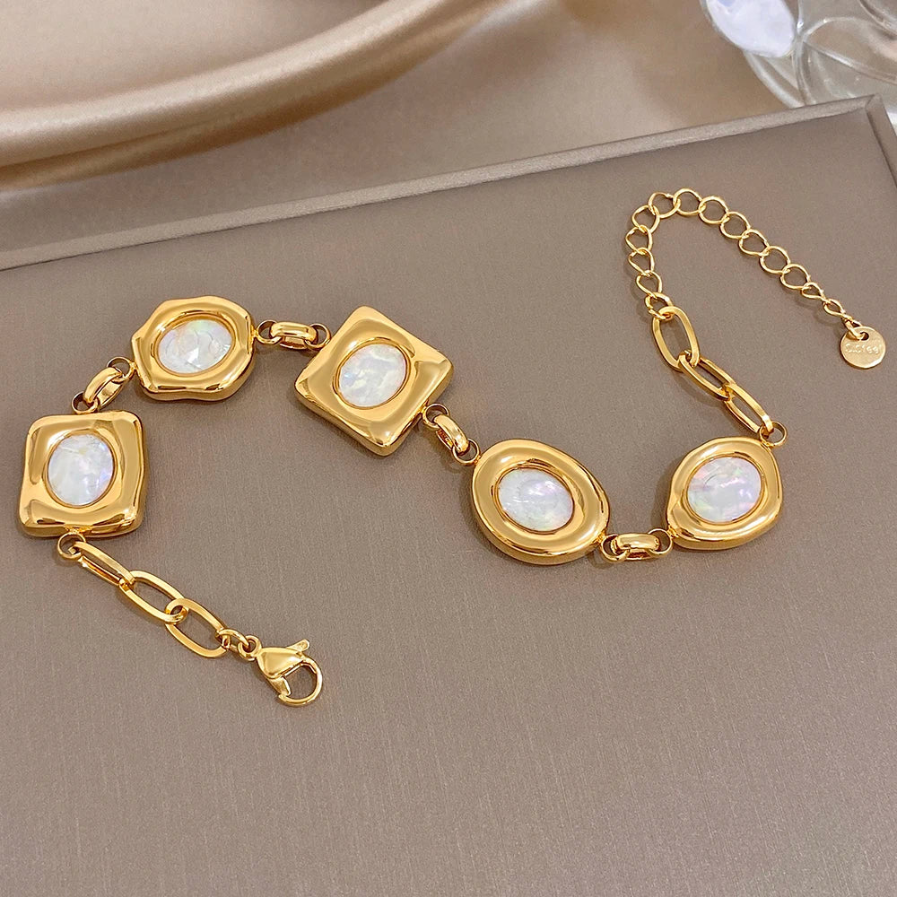 Gold-plated geometric shell bead bracelet with loop chain and square/oval white inlays