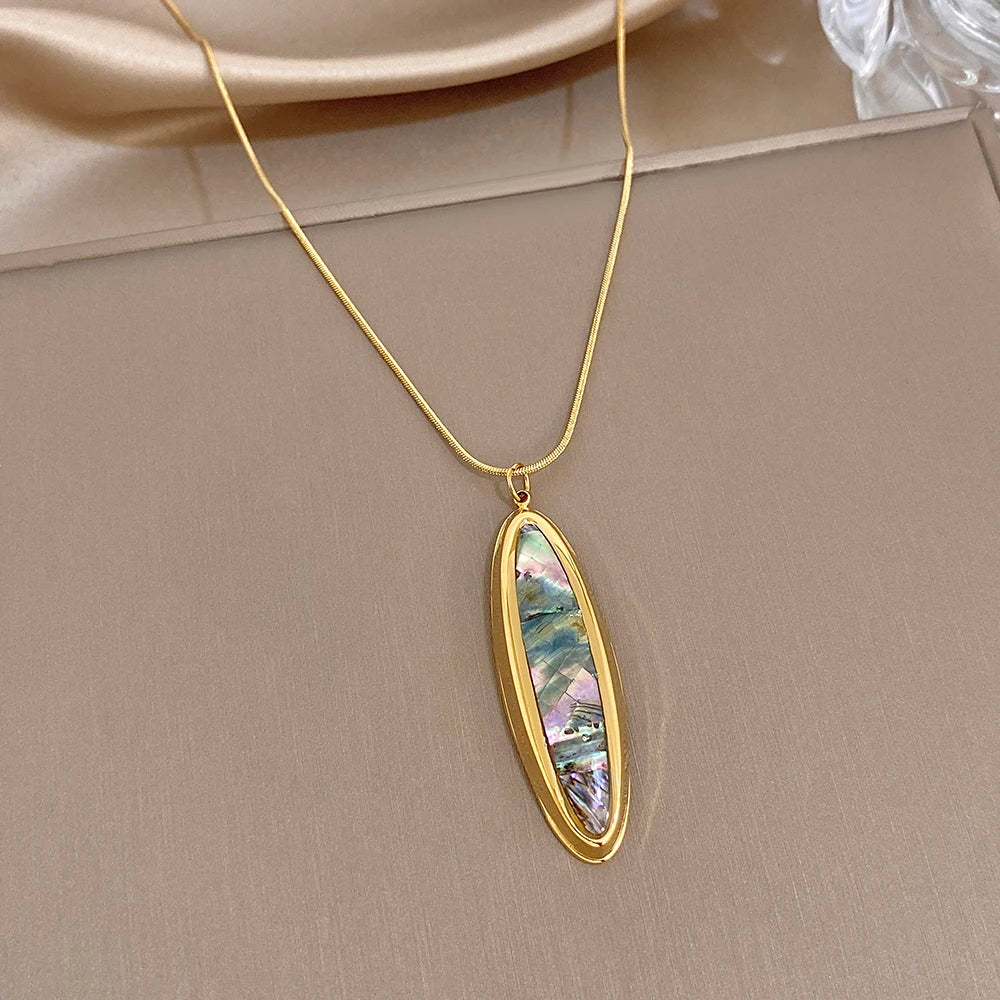 Gold-tone oval abalone shell pendant necklace with long thin snake chain
