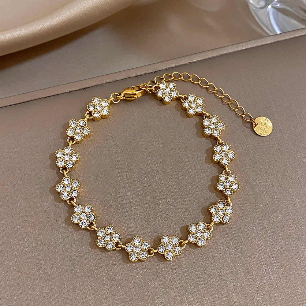 Gold-tone flower zircon bead bracelet with clear stones, round links and chain clasp