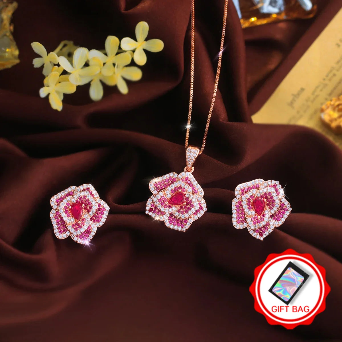 Rose-red flower CZ pendant necklace and matching earrings, with gift bag icon