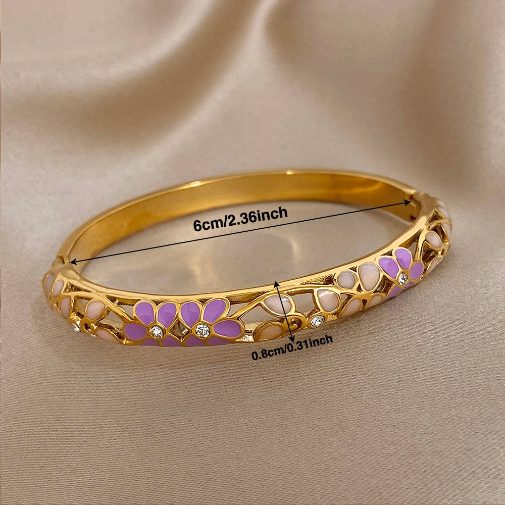 Gold-plated cuff bangle with purple and white enamel flowers and crystal detail
