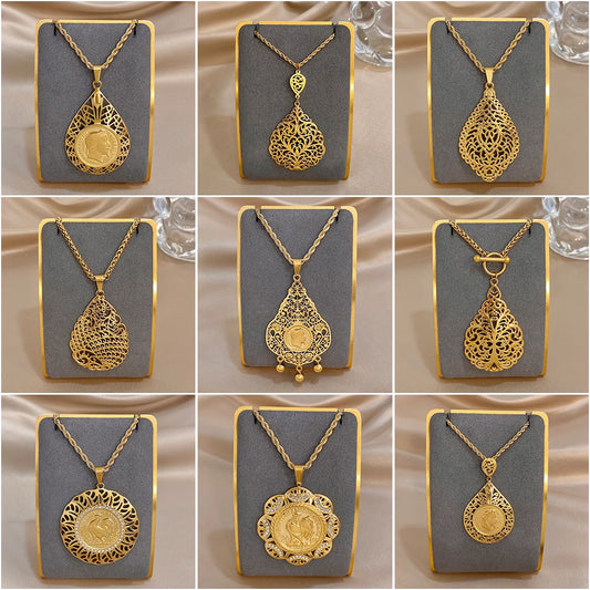 Gold-tone necklace pendants with ornate hollow flower and teardrop charms on display cards