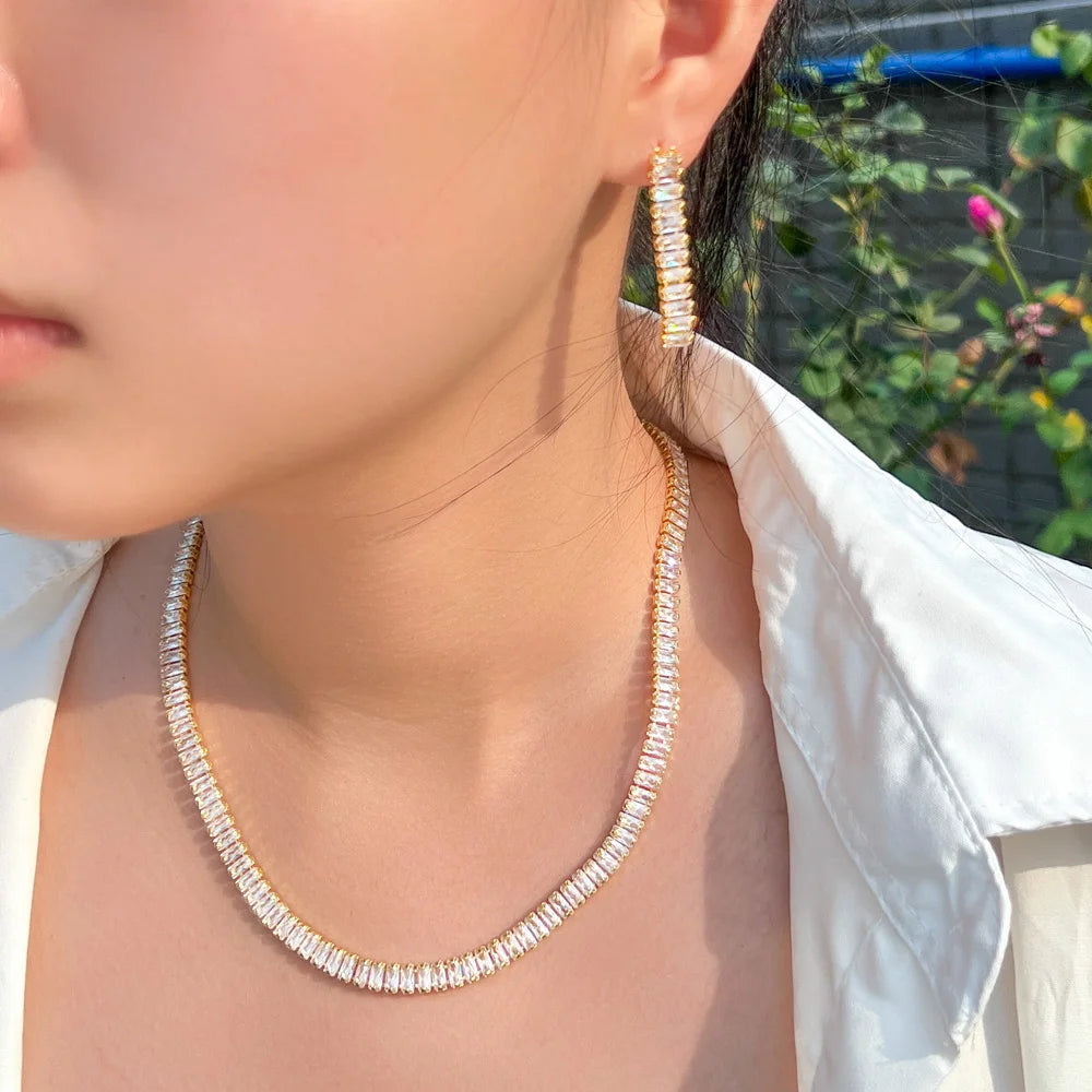 Gold-tone rectangular stone necklace and matching long drop earring, worn