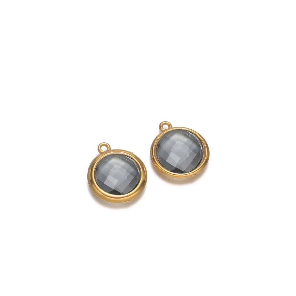Round charcoal gray faceted glass charm pendants with gold-tone frames and loop hooks