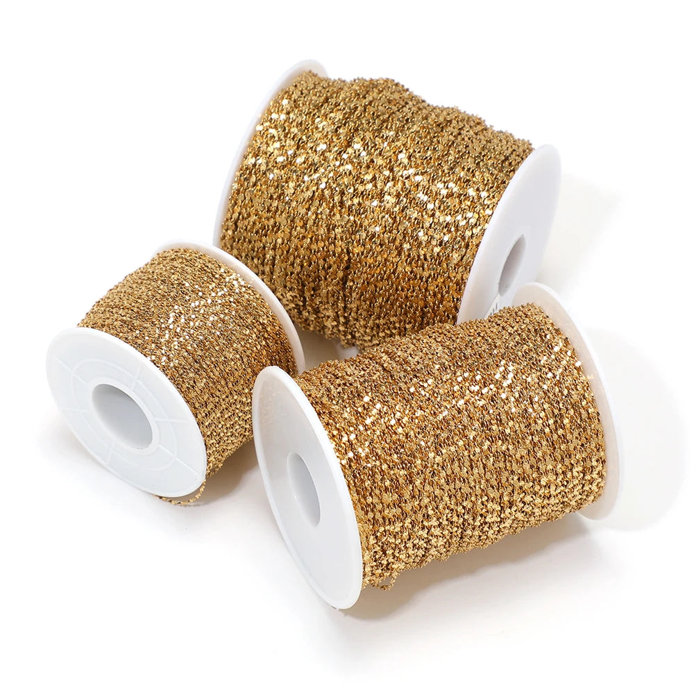 Gold plated flat flower chain rolls on white spools, assorted spool sizes for DIY jewelry