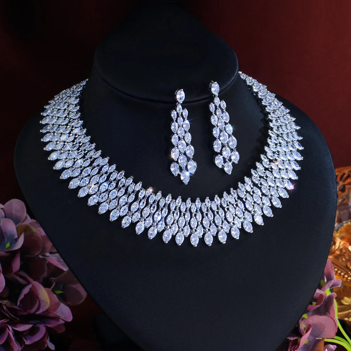 Cubic zirconia pave necklace and oval drop earrings set on black bust, silver-toned