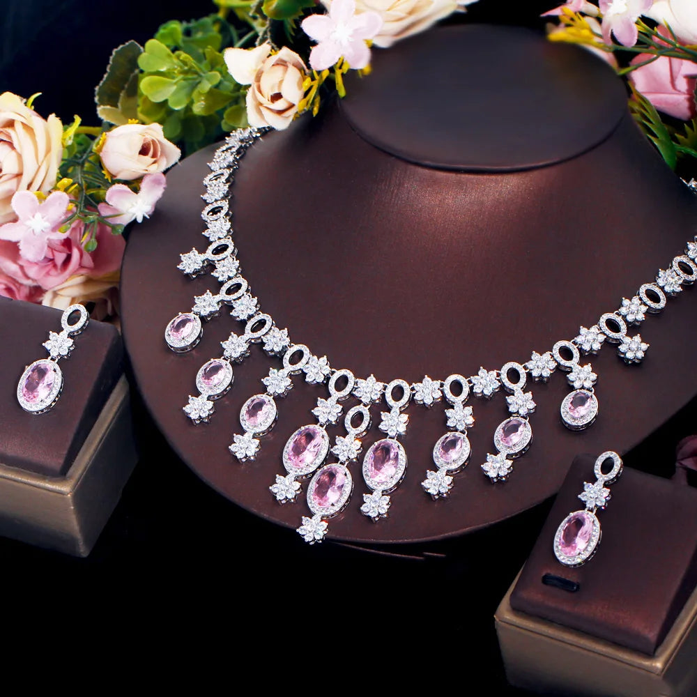 Pink oval stone necklace and matching earrings with dangling floral crystal details