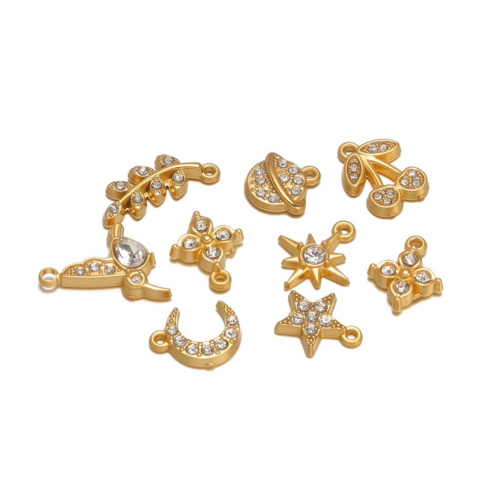 Mixed gold-tone rhinestone charm pendants with hanging loops: moon, star, clover, bird, cherry