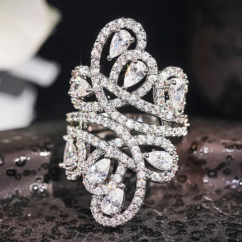 CZ hollow pattern ring with teardrop-shaped stones and pavé setting