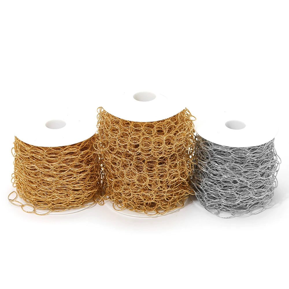 Spools of gold, silver, and dark-gold hollow oval link chain with ring texture
