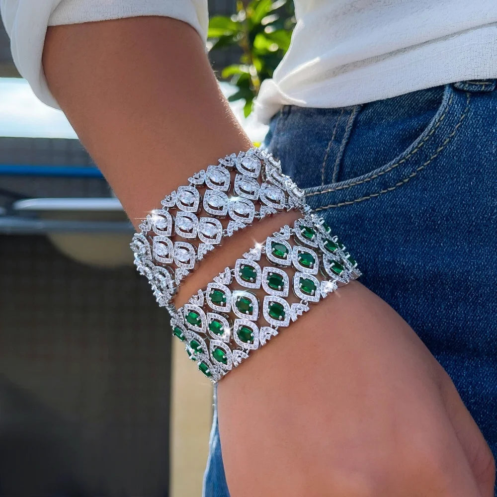 Green and clear zirconia wide bracelets shown wrapped around a wrist