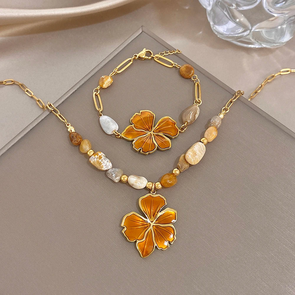 Gold plated necklace with orange enamel flower pendant and mix of stone beads