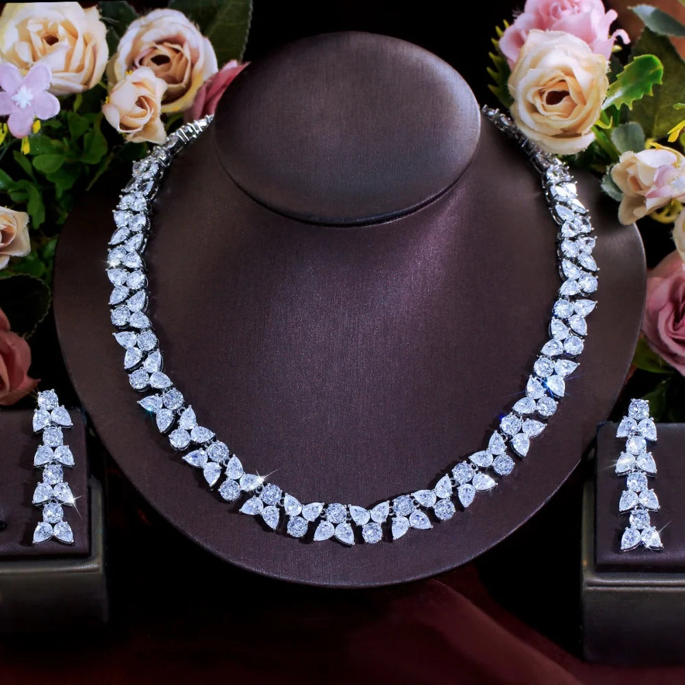 Clear zirconia leaf necklace and matching dangling earrings displayed as a set