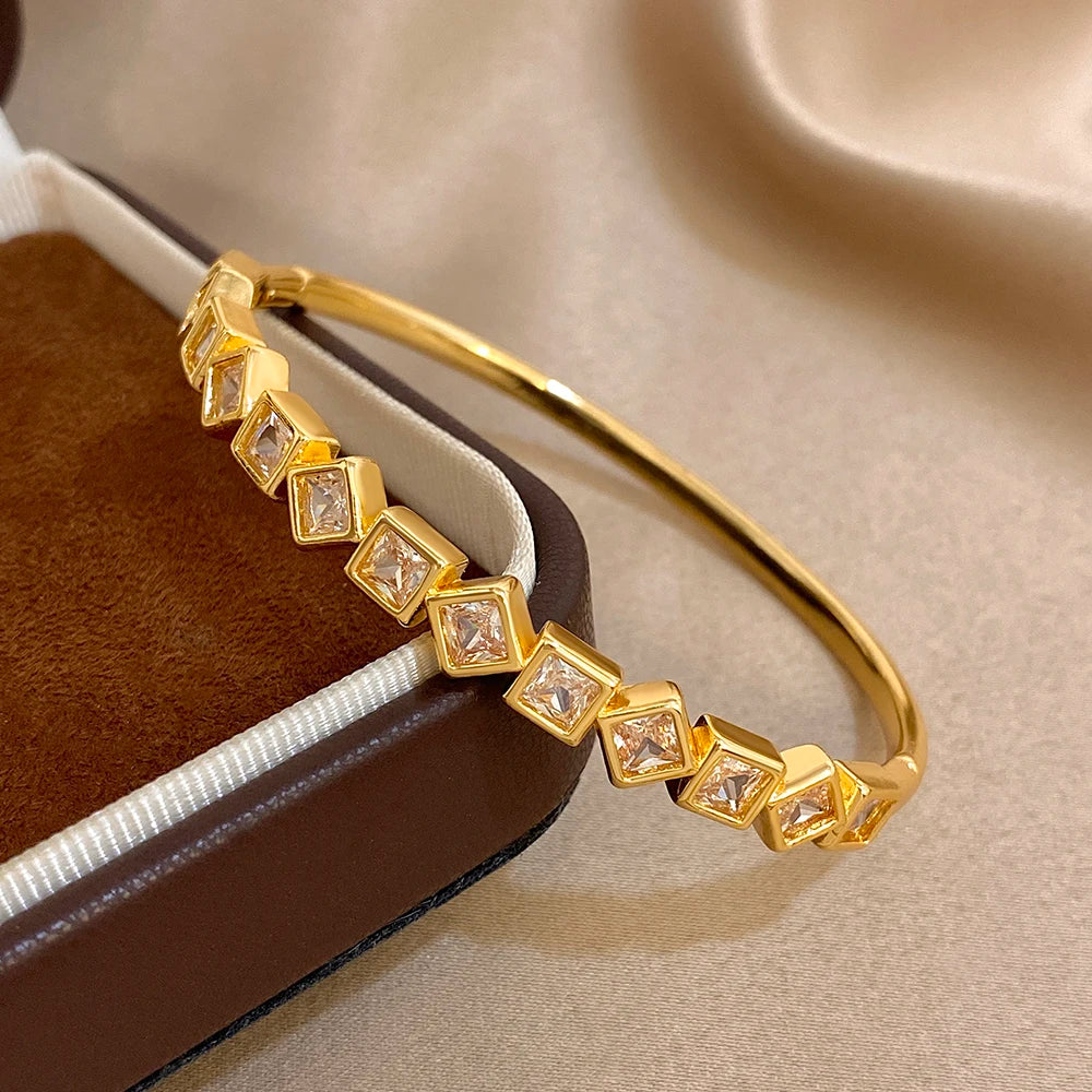 Gold-tone geometric zircon cuff bracelet with faceted square clear stones